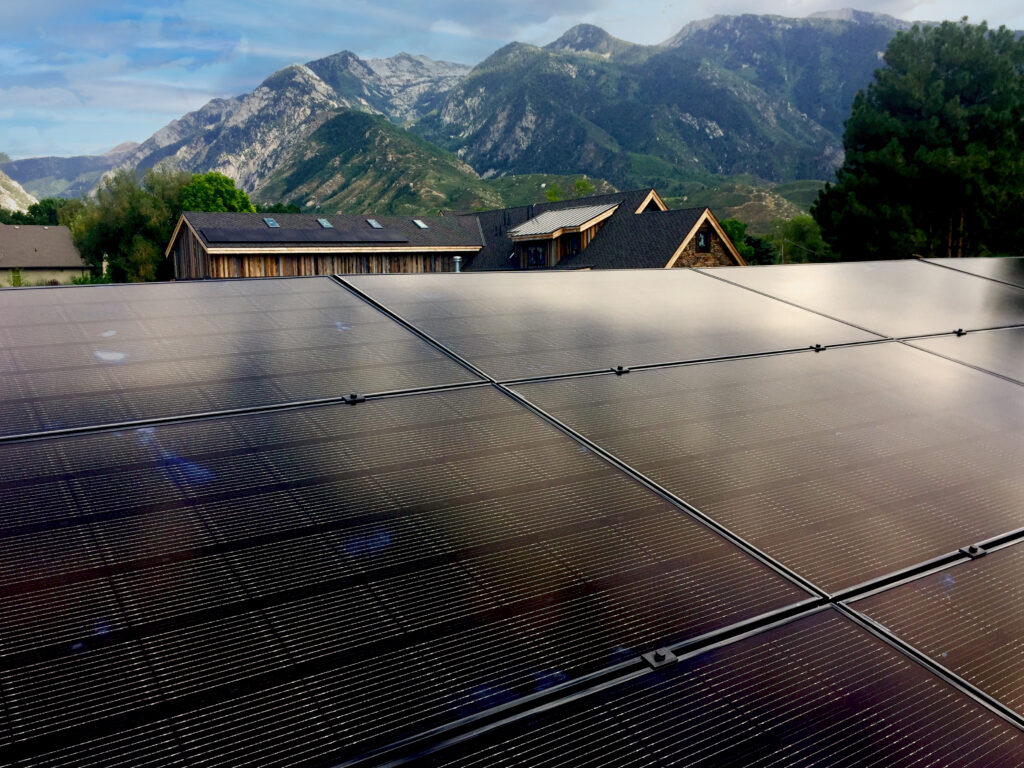Solar panels installed on a Utah rooftop with mountain range visible in the background
