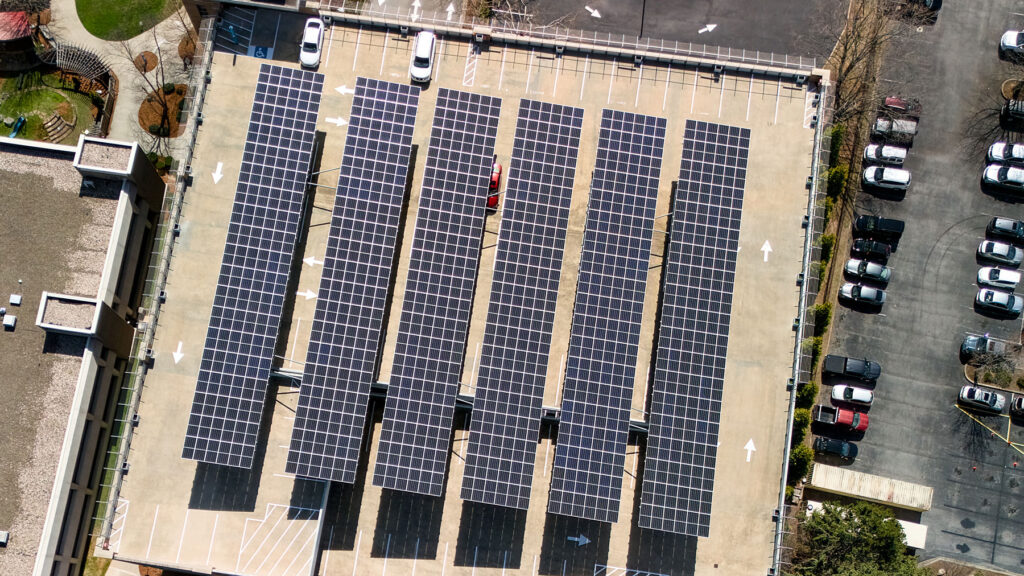 Aerial view of commercial solar panel arrays installed over a Utah parking structure.