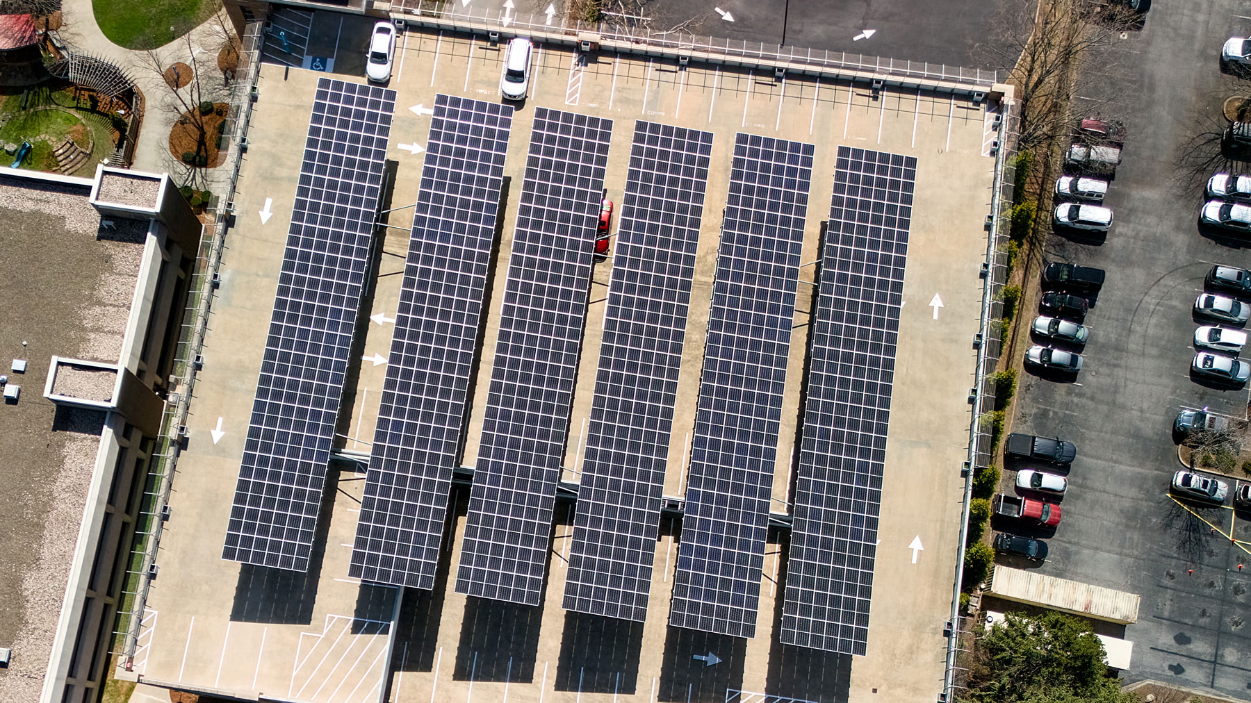 Aerial view of commercial solar panel arrays installed over a Utah parking structure.